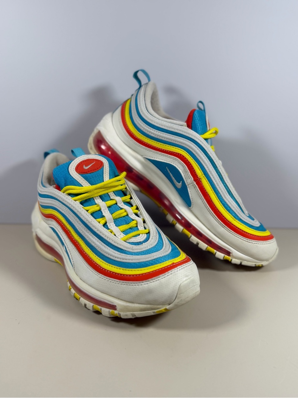 Nike White Sneakers with Blue, Red, Yellow & Teal Accents